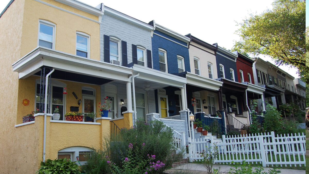 Painted stucco and formstone row houses. 
