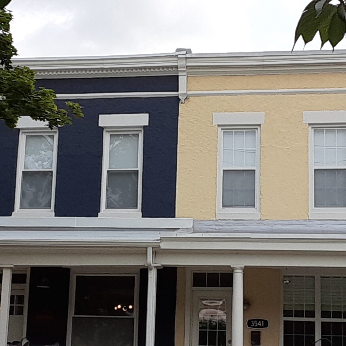 Detail of rowhomes with roofline moulding.