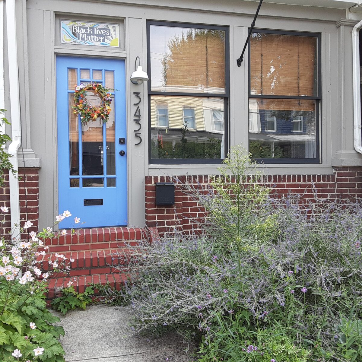 A craftsman style paned glass front door painted a cheerful blue.