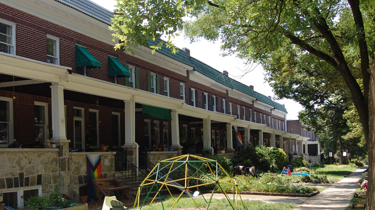 Rowhomes on a tree lined street.